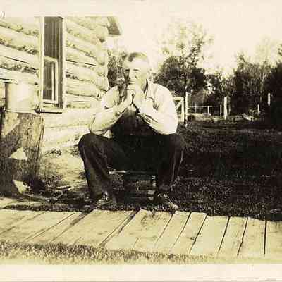 Photo of Unidentified Man in Yard of Cabin from the Mohler/Follett Family