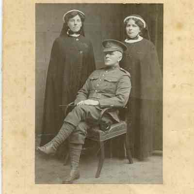 Photograph "Studio portrait of a PPCLI Private alongside two women in uniform."