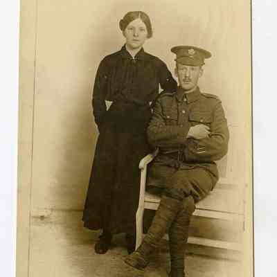 Postcard "Unidentified RPPC of a 4th Battalion soldier alongside a woman in civilian clothes."