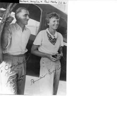 Amelia Earhart and Paul Mantz posing with aircraft, Tulsa Airport