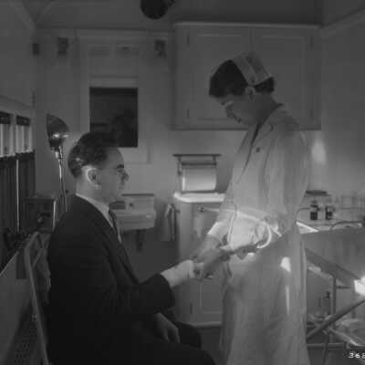 Photograph, Canadian National Railways (CNR) Medical Clinic Car - patient receiving treatment.