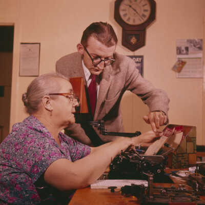 Photograph, Magistrate Jack White with operator Miss May Kennedy at the Canadian National Telegraph office, Woody Point, Bonne Bay, Newfoundland.