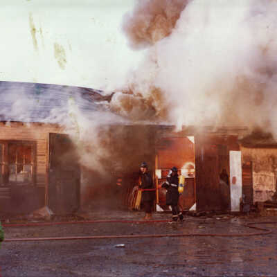 Photograph - Two firefighters putting out warehouse fire, Capreol