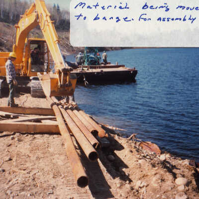 Photograph, Train Derailment, 1988, Set of 175 Pictures. "Material being moved to barge for assembly"