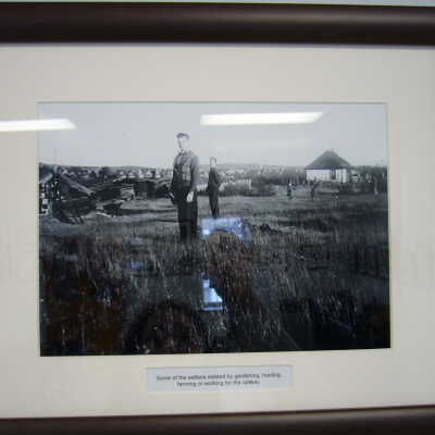 Photograph - Two unidentified men standing in a field