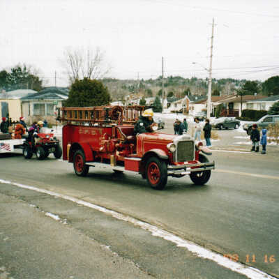 Photograph - Firefighter driving a Bickle Combination Pumper in the Capreol Santa Claus parade; 2003