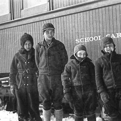 Photograph - School car class of four students at Doherty; Temiskaming & Northern Ontario school car; date may be early