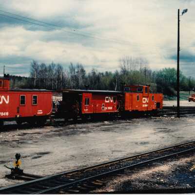 Photograph- CN Cabooses no. 78416, no. 76558, no. 56497, and one other.
