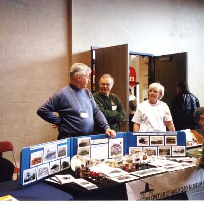 Bob & Fran Michelutti and Dale Wilson at the NORMHC table for the 2002 Toronto Model Railway Show (March 23/24, 2002)