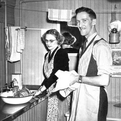 Photograph - Angus and Helen McKay doing dishes on the T&NO school car, 1945