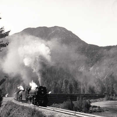 Photograph: "CPR Doubleheader. The Dominion with two Selkirk locomotives in Alberta Canyon, B.C."