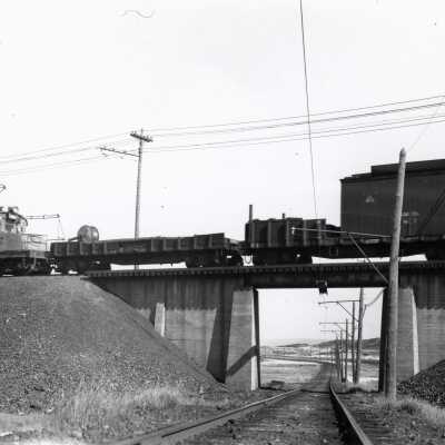 Photograph, INCO Locomotive 104 and Line Car, SCC Crossing.
