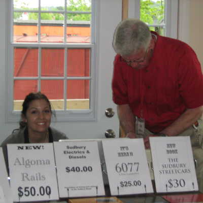 Photograph, NORMHC, Krista Fitzsimmons assists with Nickel Belt Rails display at 2011 Open House.