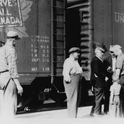 Photograph- Addie Sweezey In Front of CN and Union Pacific Cars.