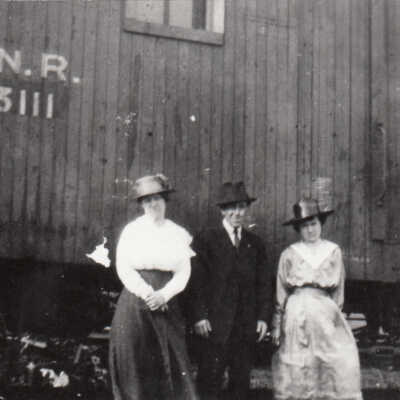 Photograph- "C.N.R 63111 Box Car House With Three People In Front"