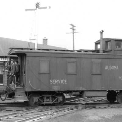 Photograph, Algoma Central Service Caboose 106531 on southbound work train at Franz, ON.