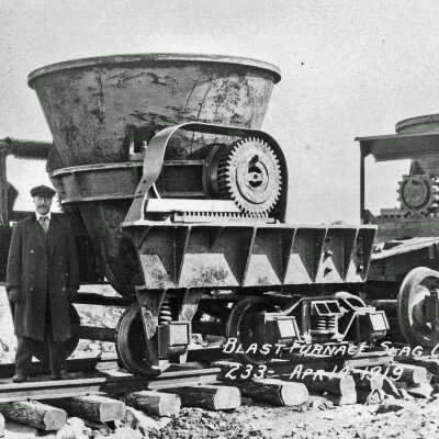 Photograph - Man posing with blast furnace slag car, 1919