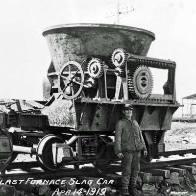 Photograph - Man posing with blast furnace slag car, 1919