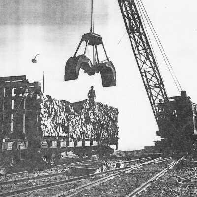 Photograph - Northern Paper Company pulp wood loader removes pulpwood from car at Michipicoten Harbour