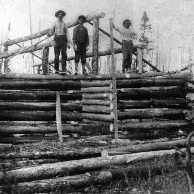 Photograph - First log cabin in Capreol. Frank Dennie, John Ownes, George Ranger, Fred Ranger, cleared the land in Capreol for the first log cabin on October 19th 1911, This Picture shows the men raising the cabin roof (Dennie on the right).