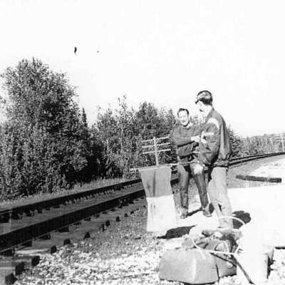 Photograph of Railroad Workers or tourists waiting to flag down a train for pickup