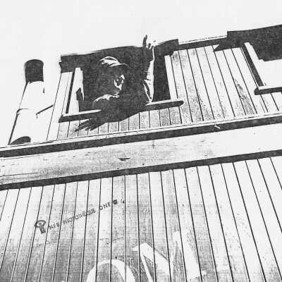 Photograph - Brakeman F.N. Beaudet waves from cupola window of the caboose as train pulls out of Tabor, Ontario