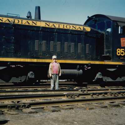 Photograph - Unidentified man posing in front of Canadian National Railways locomotive no. 8533