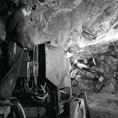 Photograph, Ore Being Drilled With a Small Pneumatic Jumbo Drill.