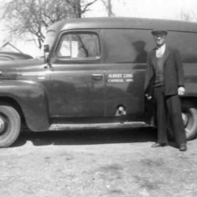 Photograph - Man standing before Ling Heating truck, 1955