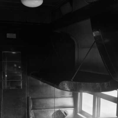 Photograph, Canadian National Railways (CNR) car - inside luggage compartment above passenger seat.