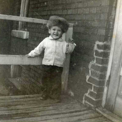 Photograph - Young Patrick Sweezey standing at the back door of his home above the Capreol fire hall