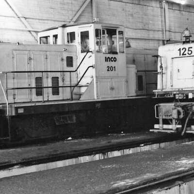 Photograph - INCO locomotives 201 and 125 in a garage (?)