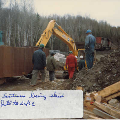 Photograph, Train Derailment, 1988, Set of 175 Pictures. "Barge sections being skid down hill to lake"