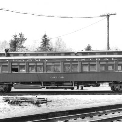 Photograph, Algoma Central Cafe Car 603 at Franz, ON, about to cross the CPR main line.