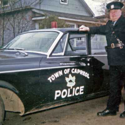 Photograph, Capreol Police Chief Alex MacAtee, 1962 Plymouth Belvedere Police Car, Capreol, Ontario.