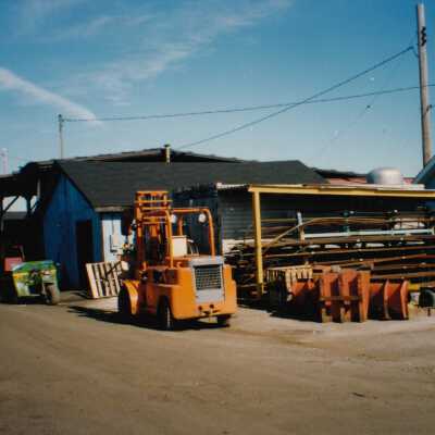 Photograph - Fork lift outside unidentified garage