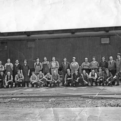 Photograph - Group portrait taken outside a boxcar