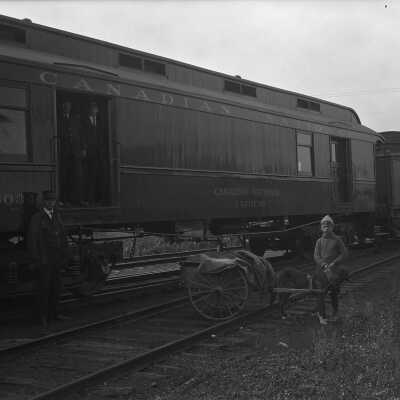 Photograph, Handling mail with dog team to Canadian National Railways Express Mail car.