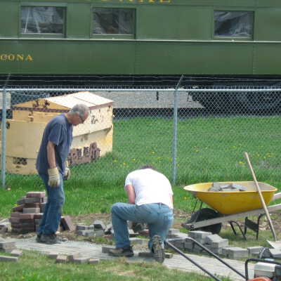 Photograph, NORMHC, Director Bob Michelutti, Volunteer laying lockstone in Prescott Park.