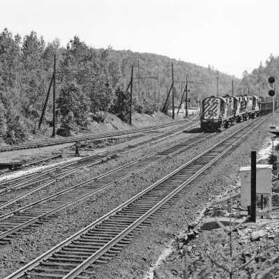 Photograph - CP locomotive no. 8780 and empty ore entering former WB main at Levack, ON
