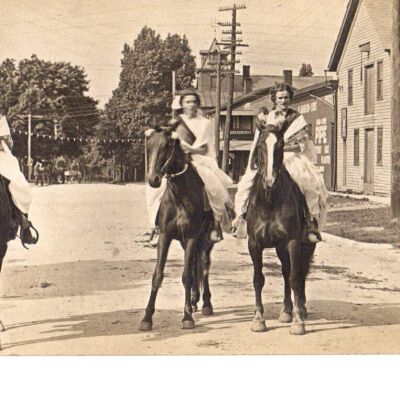 Four girls on horseback in parade