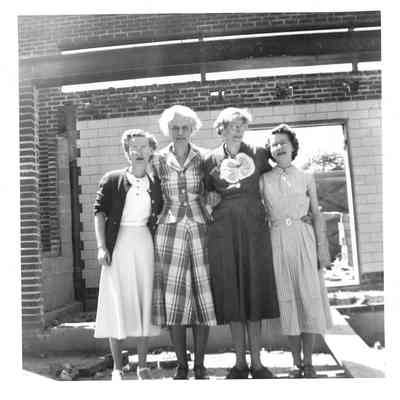 Librarians standing in front of new library construction