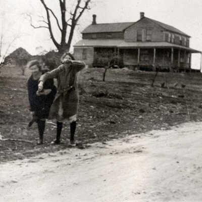 Two Women in Front of Farmhouse