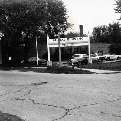 Hejhal Oldsmobile Car Dealership sign, northeast corner of W. First Street and Larch Avenue