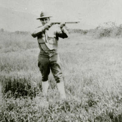 Man with gun in field