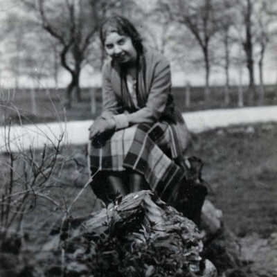 Young Woman Sitting on Stump