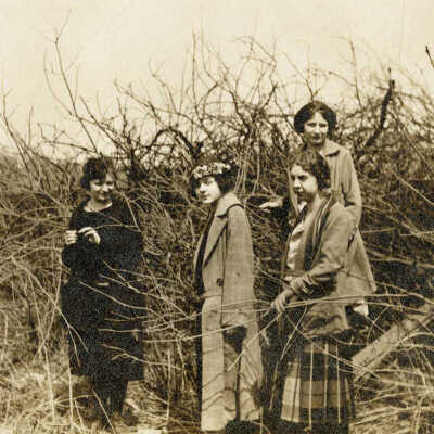 Four Women Walking Through a Bush