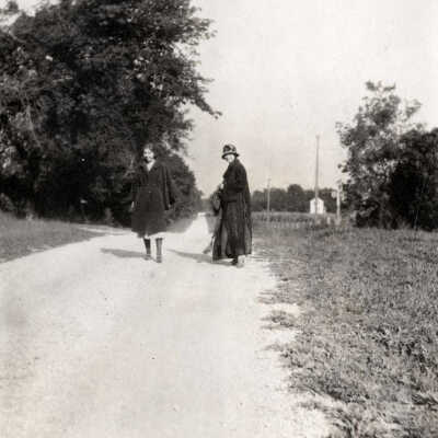 Two Women Walking on Road