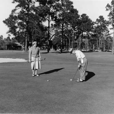 Golfing at Lakewood Golf Club in the late 1940's - clubhouse is nestled in the pines.