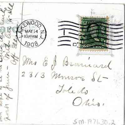 Back of the postcard: The postcard features handwritten text, a green postage stamp, and is addressed to Mrs. E.J. Brainard.